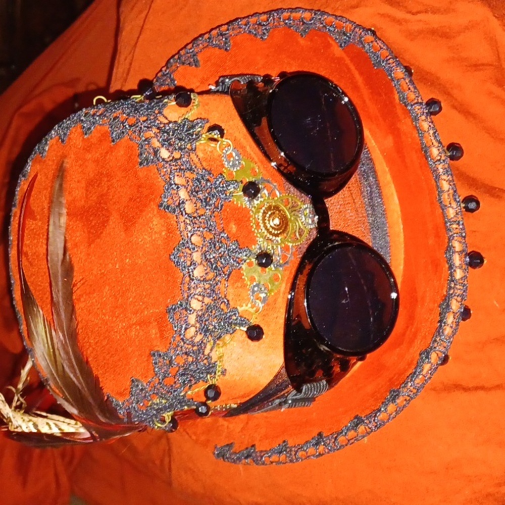 Steam punk velvet 4.25inch hat with removable goggles. It's red and has black .